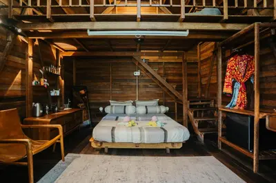 a bedroom with a bed in a wooden room at Wow Cozy Lagoon! in Nusa Dua