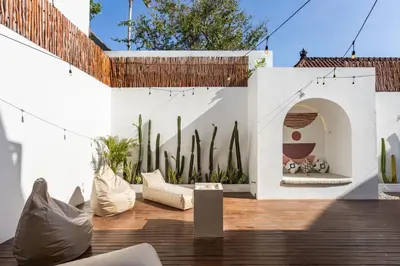 a patio with cactitious plants and a building at Luxury 3BR Canggu | Billiards | Outdoor Cinema in Canggu