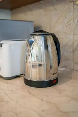 a tea kettle sitting on a counter next to a toaster at Tropical 3BR Oasis w Private Pool Villa Nau Mai in Seminyak