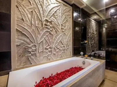 a bath tub filled with red roses in a bathroom at villa dreamland beach 300 meter private walk in Jimbaran