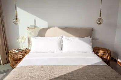 a bed with white sheets and pillows in a bedroom at Villa Kenia 1 in Umalas, near Canggu in Canggu
