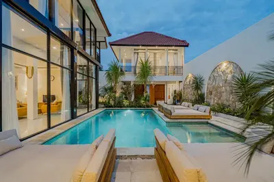 a house with a swimming pool and a house at Villa Orchid Heaven by Bali Villa Solutions in Seminyak