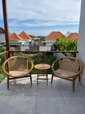 two chairs and a table on a balcony at Rumah Melissa - Modern Boho 3BR Brand New Villa in Sanur in Sanur