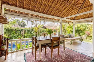an outdoor dining room with a table and chairs at Charming, Homely, Pool, Lush Gardens, Umalas, Cozy in Kerobokan