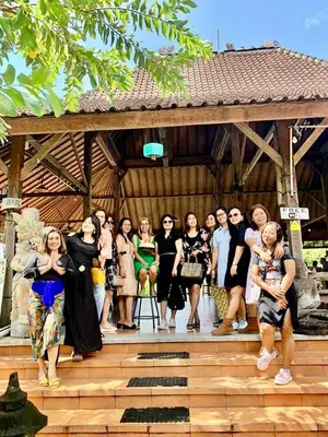 a group of people standing on a wooden stage at Balian Retreat Centre Homestay in Sanur