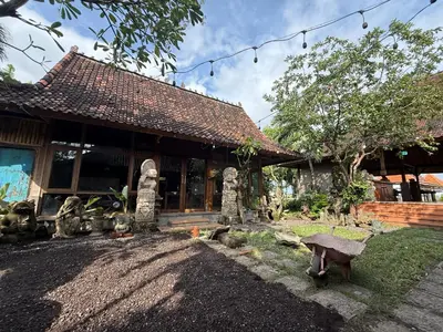 a house with a bench in front of it at Balian Retreat Centre Homestay in Sanur