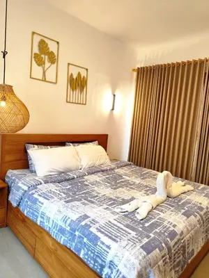 a bedroom with a bed with a stuffed animal on it at Coconut Villa in Kerobokan