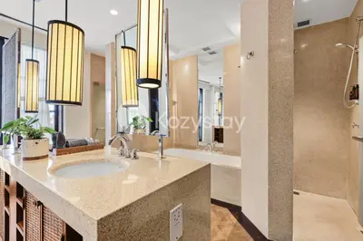 a bathroom with a sink and a large mirror at The Koral by Kozystay - Seminyak in Kuta