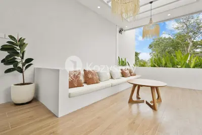 a living room with a table and a plant at Sadin Villa by Kozystay - Umalas in Kerobokan