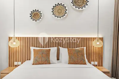 a bedroom with a large white bed with pillows at Sadin Villa by Kozystay - Umalas in Kerobokan