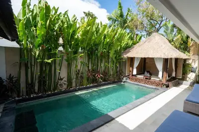 a swimming pool in front of a villa at Kangin villa 2 bedrooms in the heart of Seminyak in Kuta