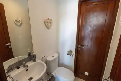 a bathroom with a toilet and a sink and a mirror at Kangin villa 2 bedrooms in the heart of Seminyak in Kuta
