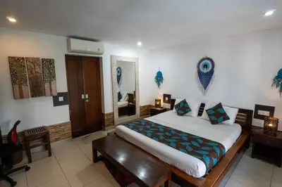 a bedroom with a large bed and a wooden table at Kangin villa 2 bedrooms in the heart of Seminyak in Kuta