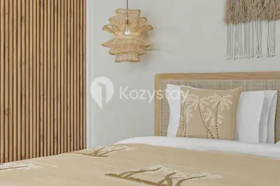 a bedroom with a bed and a chandelier at Salila Villa by Kozystay - Umalas in Kerobokan