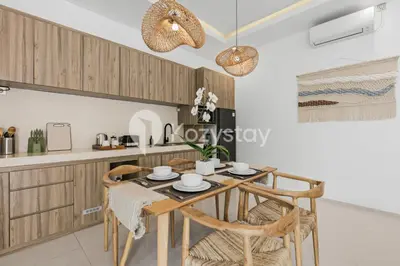 a dining room with a table and chairs in a kitchen at Salila Villa by Kozystay - Umalas in Kerobokan