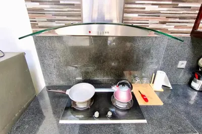 a small kitchen with a pot on a stove at Domaxo Villa in Seminyak
