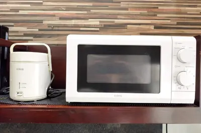 a microwave sitting on a table next to a blender at Domaxo Villa in Seminyak