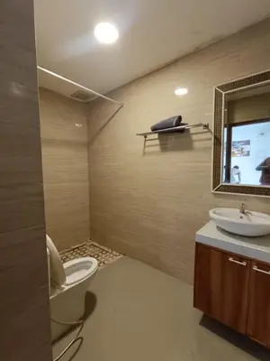 a bathroom with a toilet and a sink and a mirror at Ariani Villa in Jimbaran
