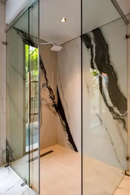a glass door in a room with a painting on the wall at Anoya Boutique Villa in Kerobokan