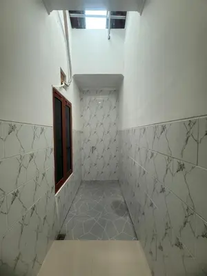 a hallway with a small window and a tile wall at Private Room In Bali 10Mints To Sanur Beach in Sanur
