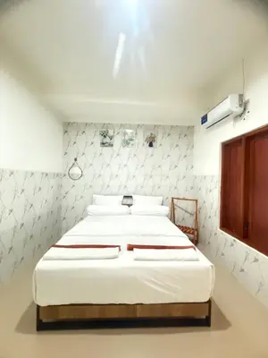 a bedroom with a large bed with white sheets at Private Room In Bali 10Mints To Sanur Beach in Sanur
