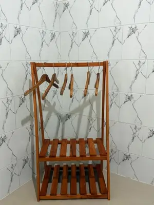 a wooden shelf with shoes hanging from a wall at Private Room In Bali 10Mints To Sanur Beach in Sanur