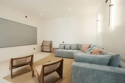 a living room with a couch and a tv at Manu Villas in Sanur