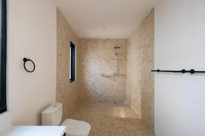 a bathroom with a toilet and a shower at Villa Seminyak Beachside Luxury in Seminyak