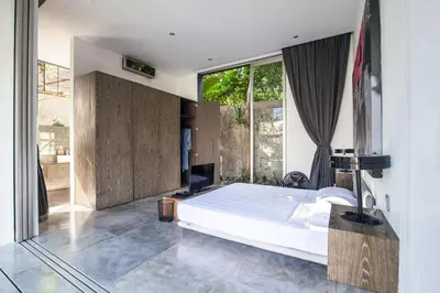 a bedroom with a bed and a large window at Modern 4BD Villa with Pool in Seminyak