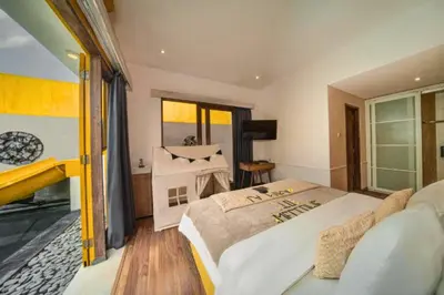 a bedroom with a large bed and a large window at Teagan Pretty 1 BR Royal Private Pool Villa With Waterslide in Kerobokan