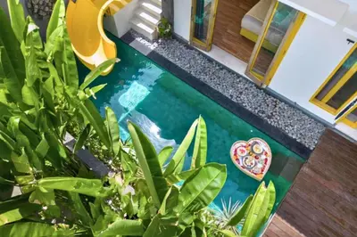 a pool with a painting on the floor of a house at Teagan Pretty 1 BR Royal Private Pool Villa With Waterslide in Kerobokan