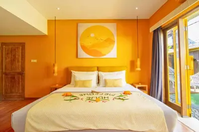 a bedroom with a large bed with orange walls at Tindra Stunning 2 BR Royal Private Pool Villa With Waterslide in Kerobokan