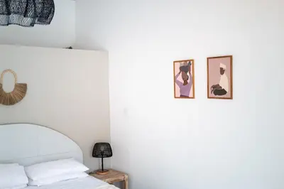 a bedroom with a bed and two pictures on the wall at Charming 3 BR villa in the heart of Umalas in Canggu