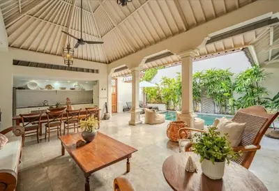 an open living room with tables and chairs and a kitchen at Seminyak Pool Villa in Seminyak