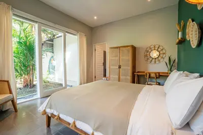 a bedroom with a large bed and a large window at Casa Oliva - Tropical Pool Villa on Trendy Seminyak Eat Street in Seminyak