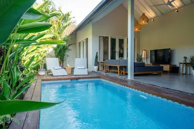 a swimming pool in front of a house at Casa Oliva - Tropical Pool Villa on Trendy Seminyak Eat Street in Seminyak