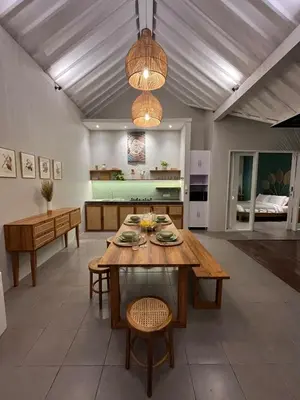 a living room with a wooden table and chairs at Casa Oliva - Tropical Pool Villa on Trendy Seminyak Eat Street in Seminyak