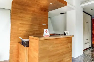 a lobby with a wooden wall and a cash register at Collection O Legian Near Pantai Kuta Formerly Premium Legian in Legian