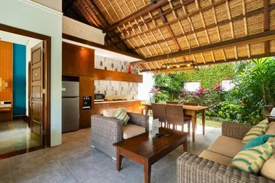 a kitchen and living room with a table and chairs at Malaya Stunning 1 BR Private Pool Villa With Bathtub in Seminyak