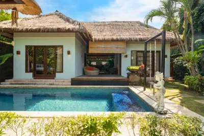 a villa with a swimming pool in front of a house at Malaya Stunning 1 BR Private Pool Villa With Bathtub in Seminyak