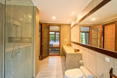 a bathroom with a shower and a toilet and a sink at Malaya Stunning 1 BR Private Pool Villa With Bathtub in Seminyak