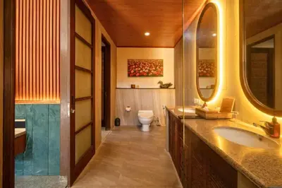 a bathroom with a sink and a toilet at Malayna Comfortable 2 BR Royal Private Pool Villa in Seminyak