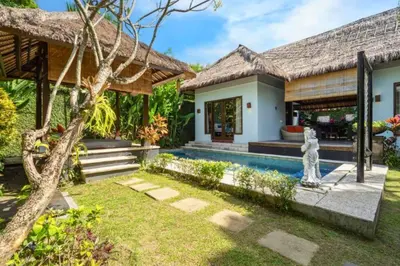 a house with a garden and a swimming pool at Malayna Comfortable 2 BR Royal Private Pool Villa in Seminyak
