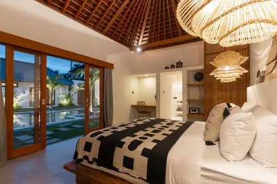 a bedroom with a large bed and a balcony at Villa Sora by Alfred in Bali in Seminyak