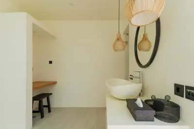 a bathroom with a white tub and a sink at Villa Sora by Alfred in Bali in Seminyak