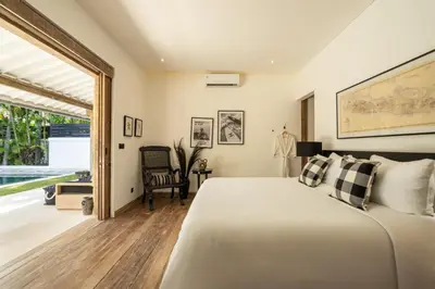 a bedroom with a bed and a large window at Luxe Bali Seminyak Villa by Betterplace in Seminyak