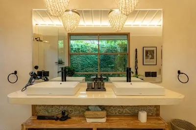 a bathroom with two sinks and a large window at Luxe Bali Seminyak Villa by Betterplace in Seminyak