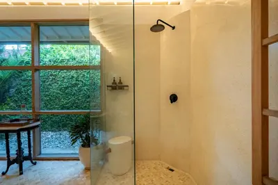 a glass shower in a bathroom with a window at Luxe Bali Seminyak Villa by Betterplace in Seminyak