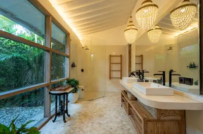 a bathroom with a sink and a large window at Luxe Bali Seminyak Villa by Betterplace in Seminyak