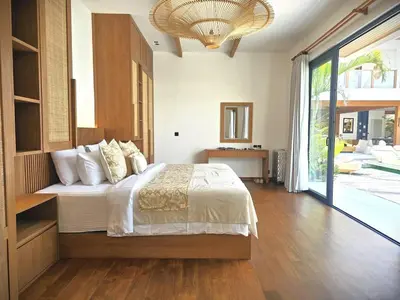 a bedroom with a bed and a large window at Villa Selena Space Luxury 4BR 15m Pool BBQ Staffed in Seminyak